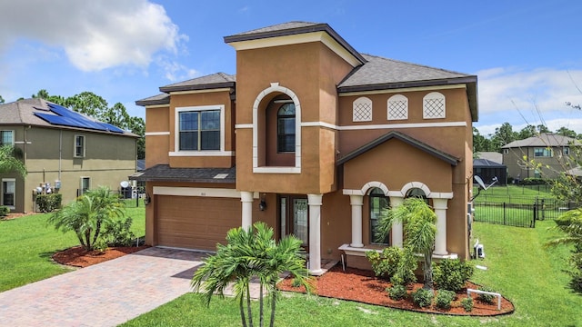 view of front of home featuring a garage and a front lawn