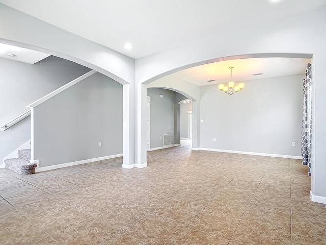 unfurnished living room with a chandelier