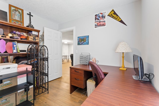 office space featuring a textured ceiling and hardwood / wood-style flooring