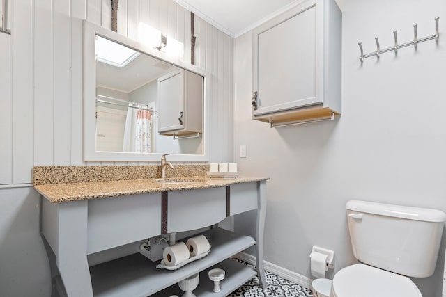 bathroom with walk in shower, crown molding, vanity, and toilet