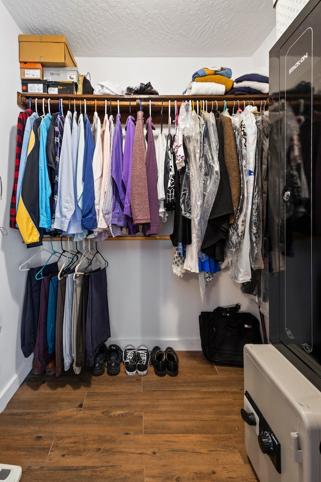 walk in closet with hardwood / wood-style flooring