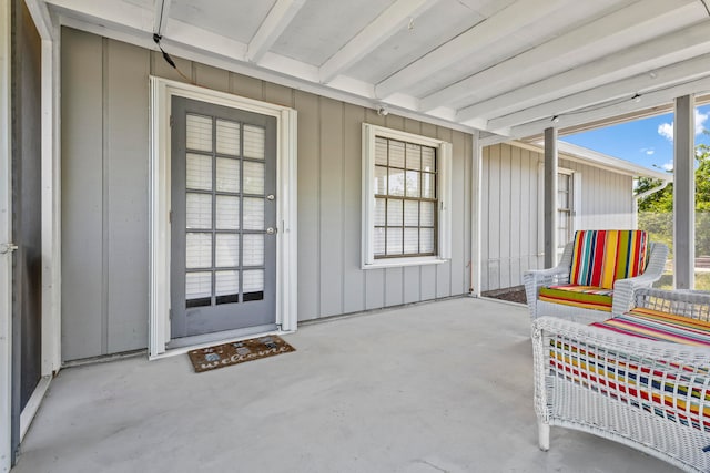 sunroom / solarium with beam ceiling and a wealth of natural light