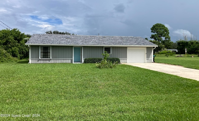 ranch-style home with a garage and a front lawn