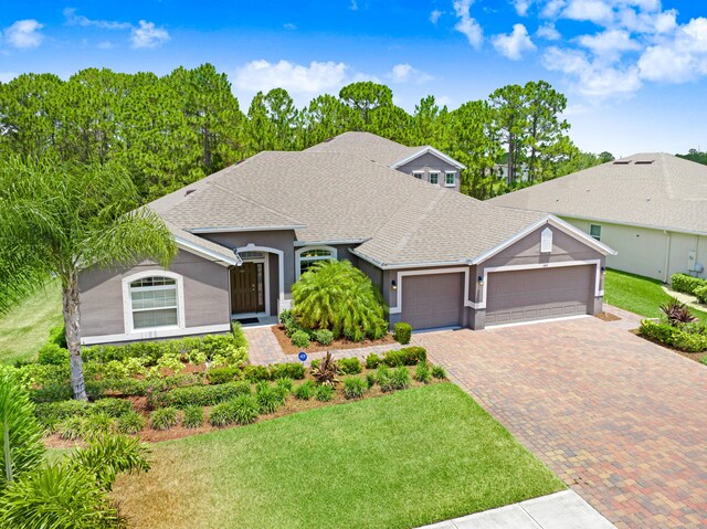 single story home featuring a front yard and a garage