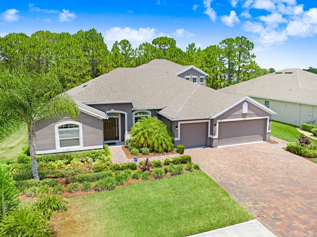 single story home featuring a front yard and a garage