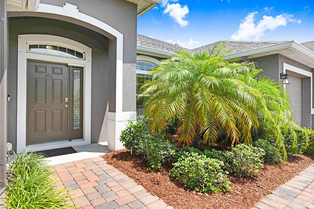 view of exterior entry with a garage