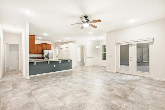 unfurnished living room with ceiling fan