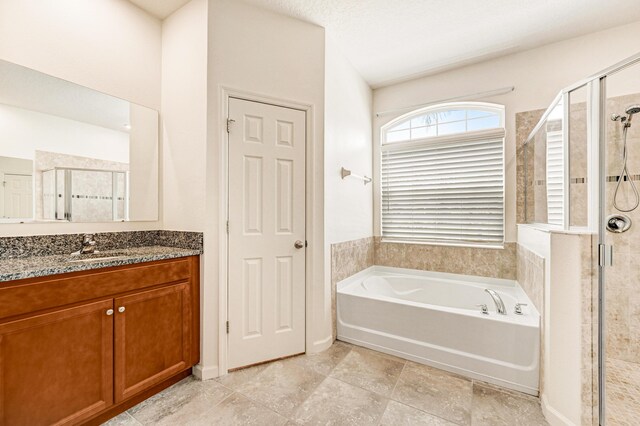 bathroom featuring independent shower and bath and vanity