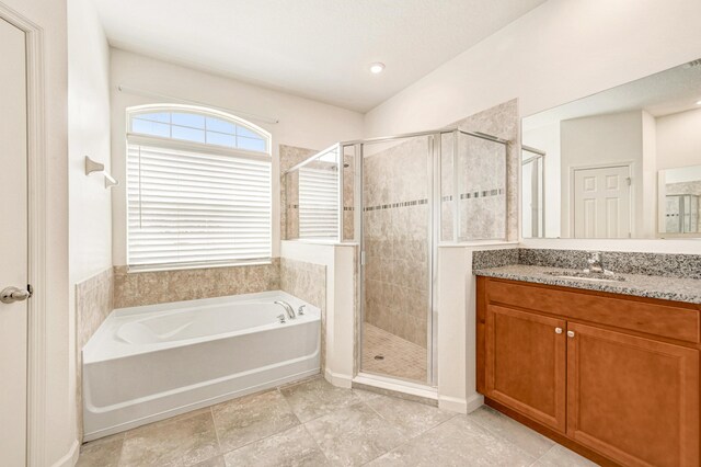 bathroom featuring vanity and shower with separate bathtub