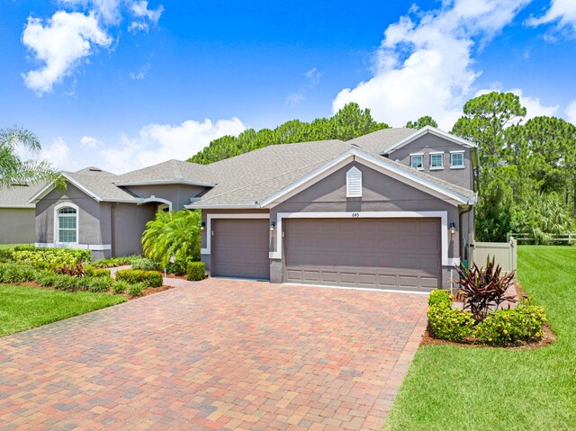 view of front facade featuring a garage and a front lawn