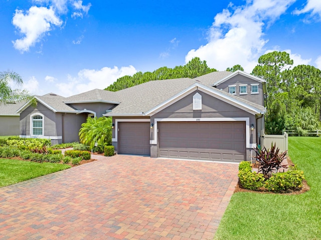 view of front facade featuring a garage and a front lawn