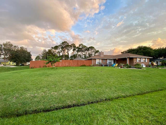 view of yard at dusk