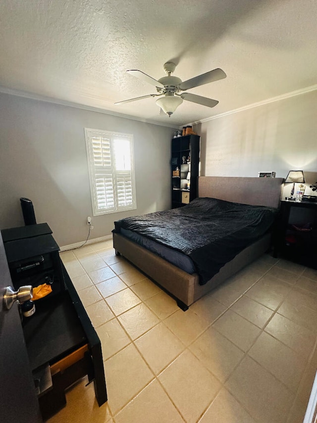 bedroom with ceiling fan, light tile patterned flooring, a textured ceiling, and crown molding