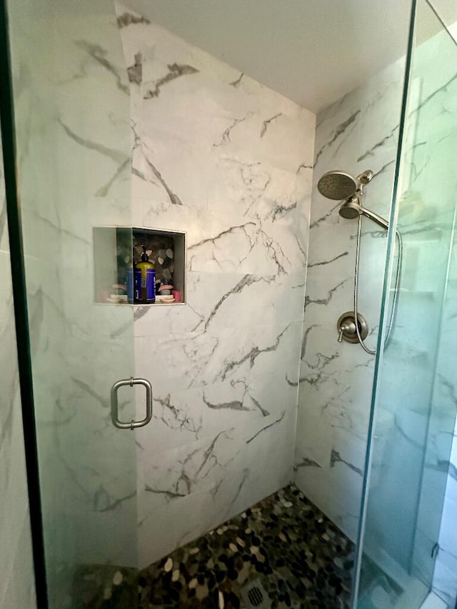 bathroom featuring a shower with door