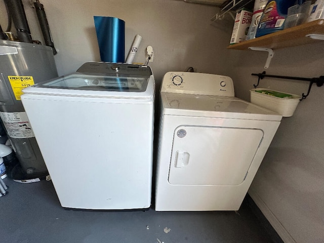 washroom featuring electric water heater and washer and clothes dryer