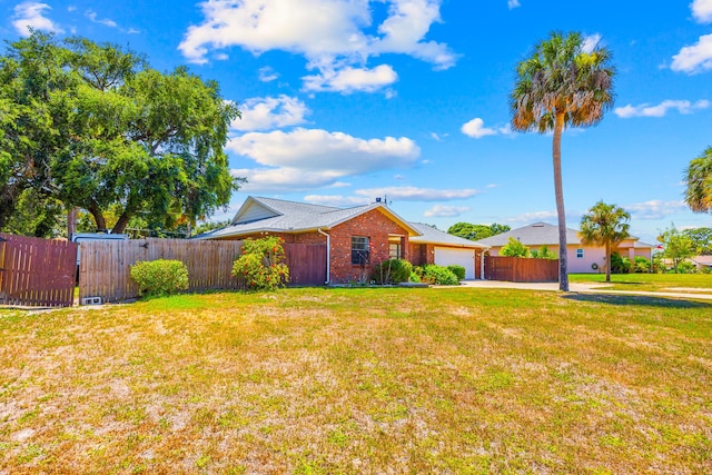 single story home with a garage and a front yard