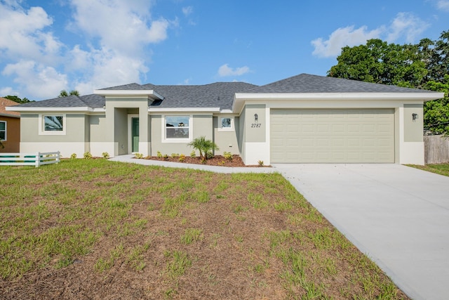 view of front of house with a garage and a front lawn