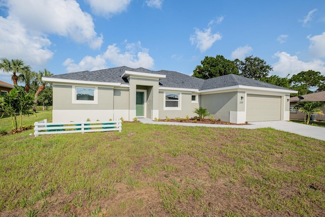 view of front of home featuring a garage and a front lawn