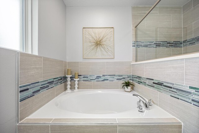 bathroom with tiled bath