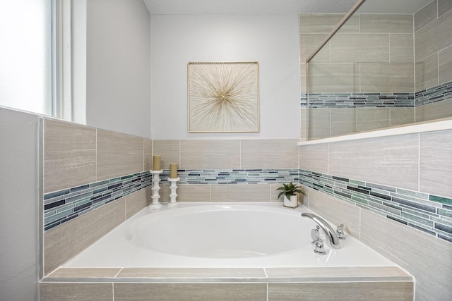 bathroom featuring a relaxing tiled tub