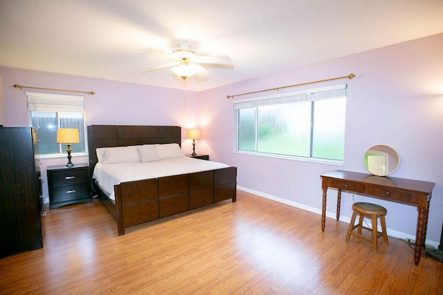 bedroom with ceiling fan and light hardwood / wood-style floors