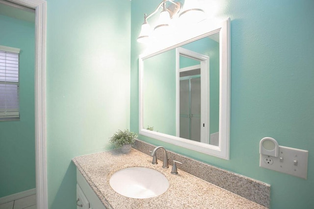 bathroom featuring tile patterned flooring and vanity