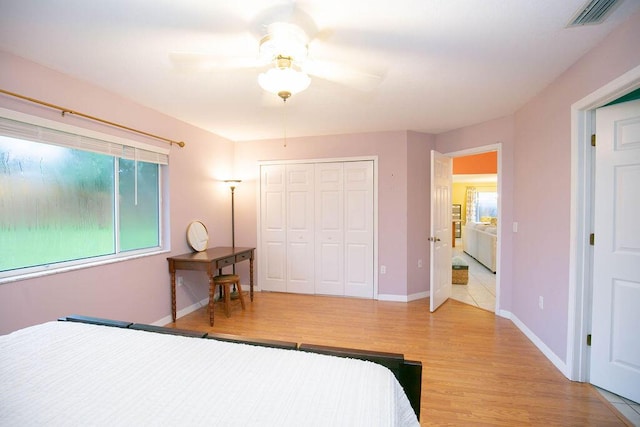 bedroom with a closet, ceiling fan, and hardwood / wood-style flooring