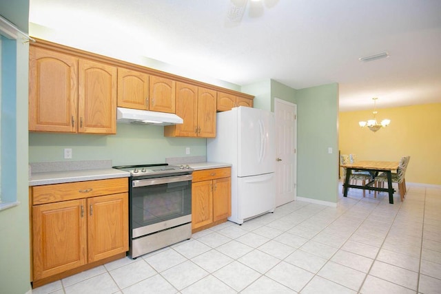 kitchen with pendant lighting, stainless steel electric range, ceiling fan with notable chandelier, light tile patterned floors, and white fridge