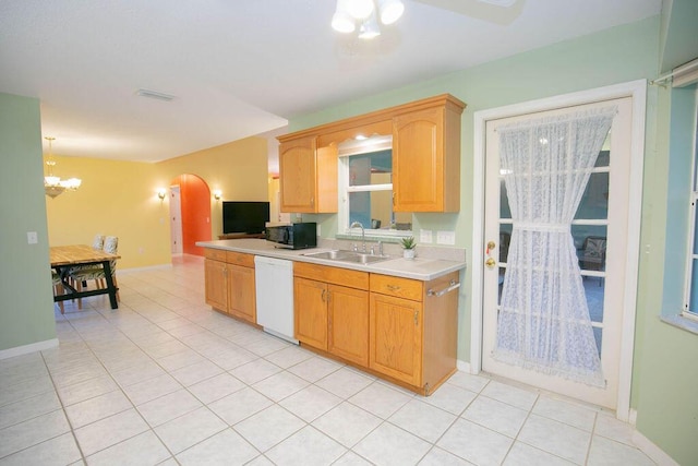 kitchen featuring white dishwasher, sink, decorative light fixtures, a chandelier, and light tile patterned flooring