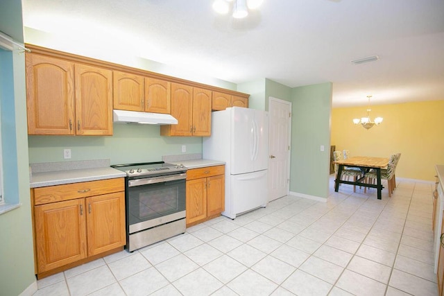 kitchen with stainless steel electric stove, light tile patterned floors, white refrigerator, an inviting chandelier, and hanging light fixtures