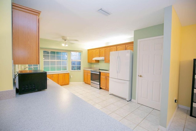 kitchen with stainless steel range with electric stovetop, ceiling fan, white fridge, and light tile patterned flooring