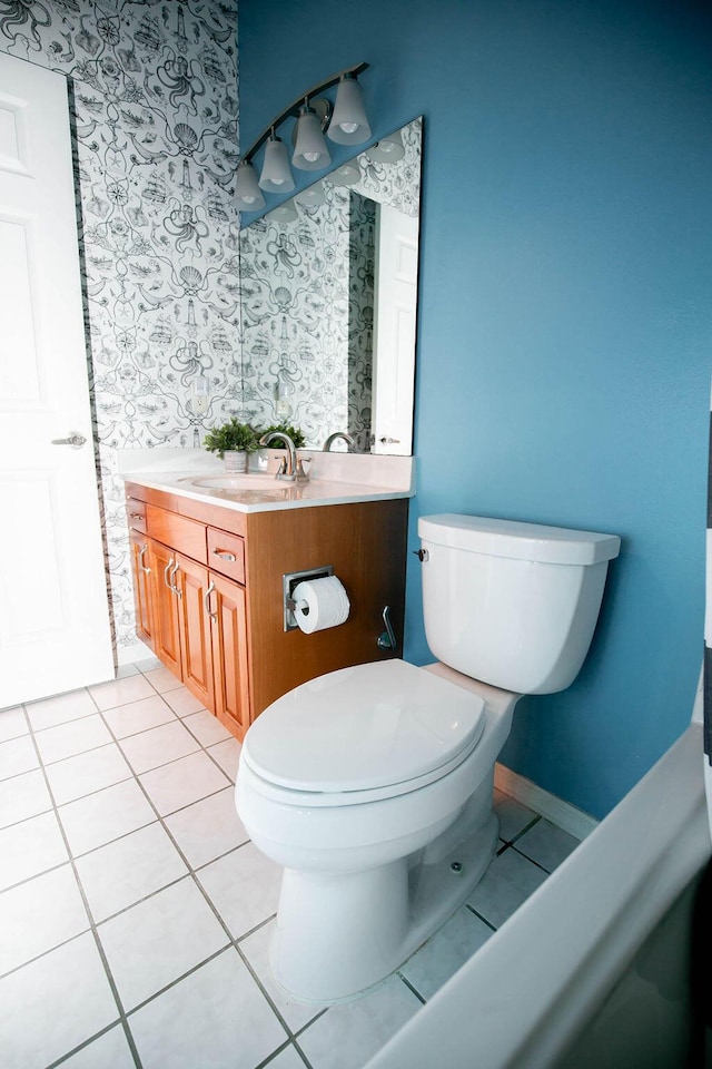 bathroom featuring tile patterned flooring, vanity, and toilet