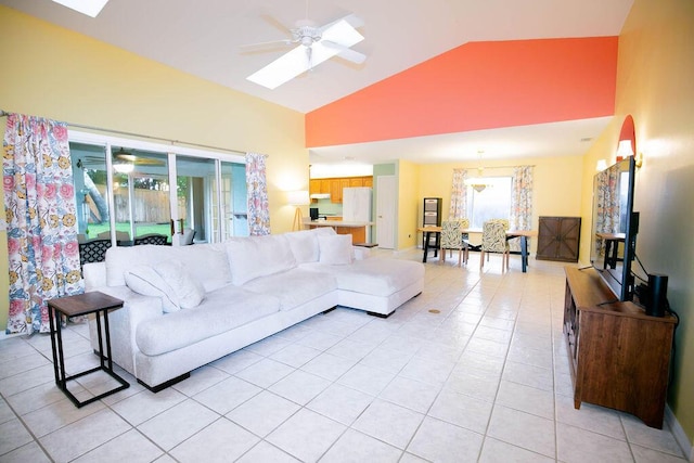 living room with high vaulted ceiling, ceiling fan, and light tile patterned flooring