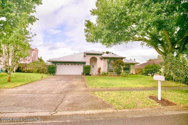 view of front of property featuring a front yard and a garage