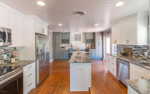 kitchen with white cabinetry, a center island, and appliances with stainless steel finishes