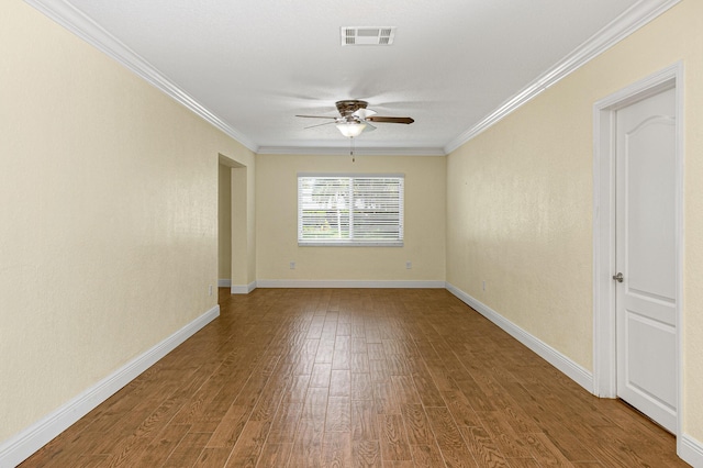 spare room featuring wood-type flooring, ceiling fan, and ornamental molding