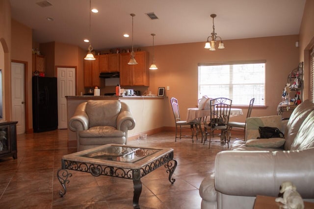 living room featuring a chandelier and tile patterned floors