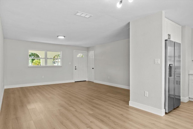 foyer entrance with light hardwood / wood-style flooring