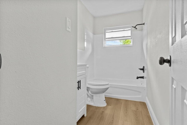 full bathroom with tiled shower / bath, toilet, vanity, and hardwood / wood-style flooring