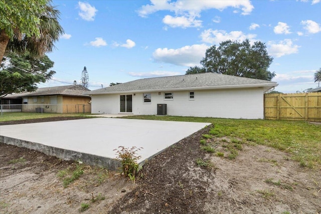 back of property with a lawn and cooling unit