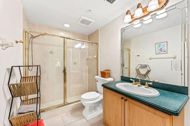 bathroom with tile patterned floors, toilet, vanity, and walk in shower