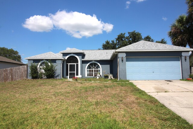 single story home with a garage and a front yard