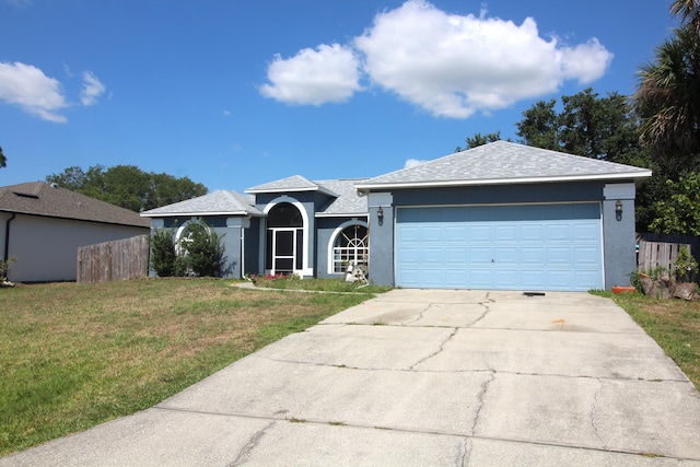 ranch-style house with a garage and a front lawn