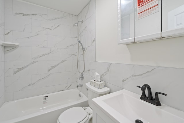 full bathroom with vanity, tiled shower / bath combo, toilet, and tile walls