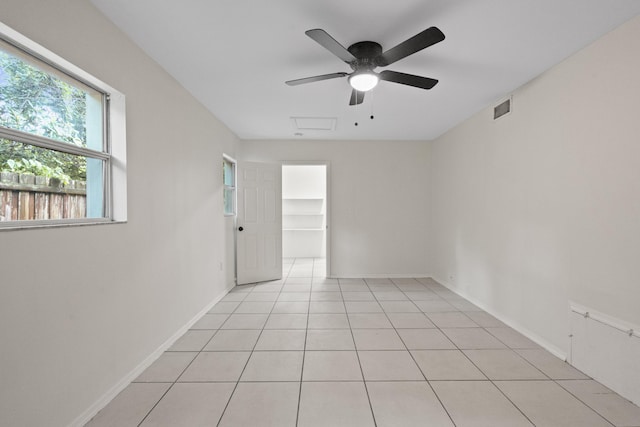 tiled empty room with ceiling fan