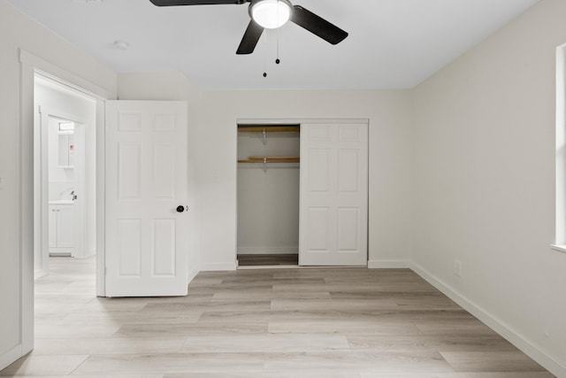 unfurnished bedroom featuring ceiling fan, a closet, sink, and light hardwood / wood-style flooring