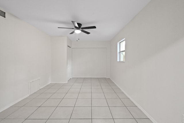 unfurnished room with light tile patterned floors and ceiling fan