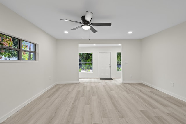 unfurnished room featuring light hardwood / wood-style flooring and ceiling fan