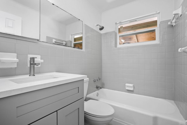 full bathroom featuring vanity, toilet, tile walls, and tiled shower / bath combo