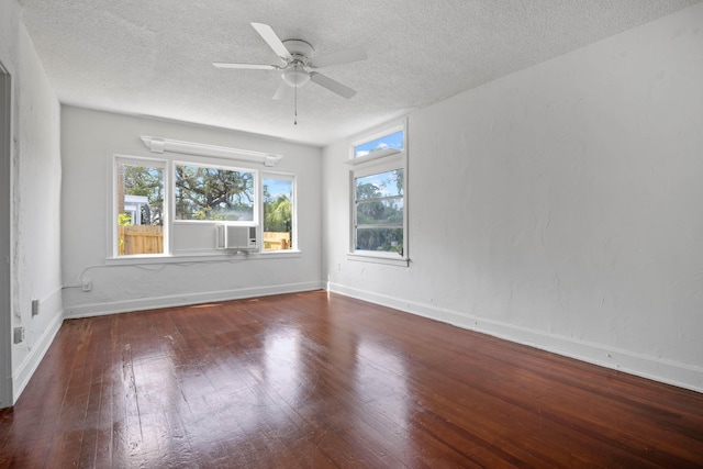 unfurnished room with ceiling fan, dark wood-type flooring, and a textured ceiling